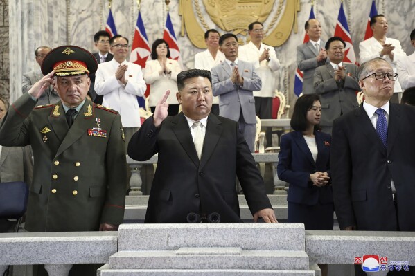 In this photo provided by the North Korean government, North Korean leader Kim Jong Un, center, Russian Defense Minister Sergei Shoigu, left, and China's Vice Chairman of the standing committee of the country’s National People’s Congress Li Hongzhong, right, attend a military parade to mark the 70th anniversary of the armistice that halted fighting in the 1950-53 Korean War, on Kim Il Sung Square in Pyongyang, North Korea Thursday, July 27, 2023. Independent journalists were not given access to cover the event depicted in this image distributed by the North Korean government. The content of this image is as provided and cannot be independently verified. Korean language watermark on image as provided by source reads: 