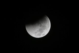 
              FILE - In this Saturday Aug. 28, 2018 file photo, Earth starts to cast its shadow on the moon during a complete lunar eclipse seen from Jakarta, Indonesia. Starting Sunday evening, Jan. 20, 2019, all of North and South America will be able to see the only total lunar eclipse of 2019 from start to finish this weekend. (AP Photo/Tatan Syuflana)
            