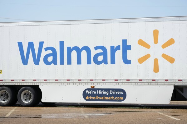 FILE - A tractor trailer bearing the Walmart logo also serves the dual purpose of advertising the company's need for tractor trailer drivers as seen in Richland, Miss., Sept. 6, 2023. Walmart is further sweetening the perks for its U.S. store managers as the nation’s largest retailer and private employer seeks to retain and attract top workers in a still competitive job market. Walmart, which is based in Bentonville, Ark. and has almost 4,700 U.S. namesake stores, said Monday, Jan. 29, 2024 that starting with the company’s new fiscal year, which begins Thursday, U.S. store leaders will receive up to $20,000 in Walmart stock grants every year. (AP Photo/Rogelio V. Solis, file)