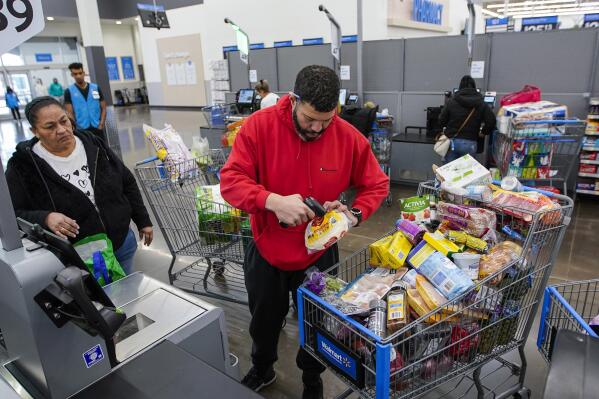 File - Francisco Santana buys groceries at the Walmart Supercenter in North Bergen, N.J. on Thursday, Feb. 9, 2023. On Friday, the Commerce Department issues its April report on consumer spending. (AP Photo/Eduardo Munoz Alvarez, File)