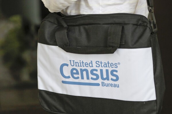 FILE - The briefcase of a census taker is seen as she knocks on the door of a residence, Aug. 11, 2020, in Winter Park, Fla. Republican lawmakers are pushing measures that would require a citizenship question on the once-a-decade census and exclude people who aren’t citizens from the head count which determines political power in the U.S. (AP Photo/John Raoux, File)