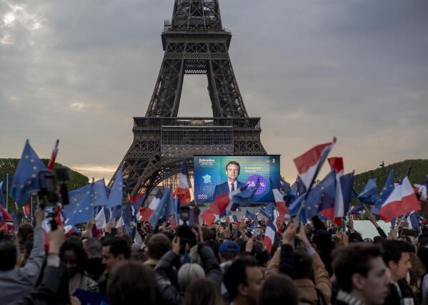French President Emmanuel Macron celebrates with supporters in front of the Eiffel Tower Paris, France, Sunday, April 24, 2022. Polling agencies projected that French President Emmanuel Macron comfortably won reelection Sunday in the presidential runoff, offering French voters and the European Union the reassurance of leadership stability in the bloc's only nuclear-armed power as the continent grapples with Russia's invasion of Ukraine. (AP Photo/Rafael Yaghobzadeh)