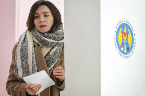 FILE- In this Feb. 24, 2019, file photo Moldova's President Maia Sandu, then leader of the ACUM opposition alliance, exits a voting cabin after casting her vote in parliamentary elections in Chisinau, Moldova. Moldova's Constitutional Court on Wednesday, April 28, 20121 canceled a state of emergency introduced to combat COVID-19 infections, enabling President Maia Sandu to dissolve parliament and call for an early election on July 11.(AP Photo/Andreea Alexandru, File)