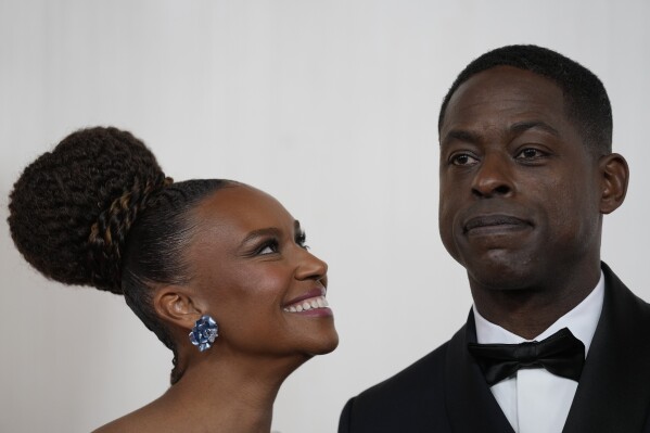 Ryan Michelle Bathe, left, and Sterling K. Brown arrive at the Oscars on Sunday, March 10, 2024, at the Dolby Theatre in Los Angeles. (AP Photo/Ashley Landis)