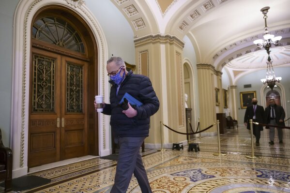 Senate Majority Leader Chuck Schumer, D-N.Y., arrives for work as the second impeachment trial of former President Donald Trump begins today in the Senate, at the Capitol in Washington, Tuesday, Feb. 9, 2021.  (AP Photo/J. Scott Applewhite)