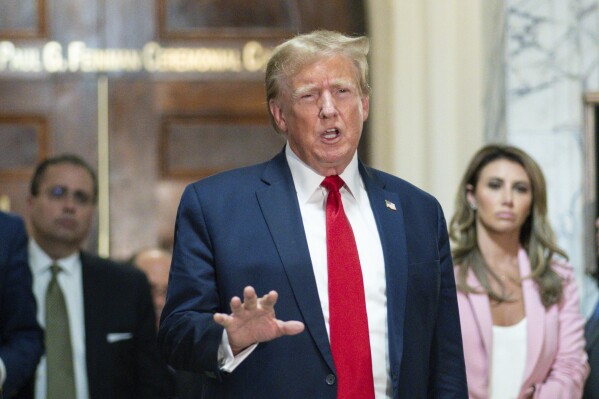 Former President Donald Trump speaks after exiting the courtroom for a break at New York Supreme Court, Thursday, Dec. 7, 2023, in New York. (AP Photo/Eduardo Munoz Alvarez)