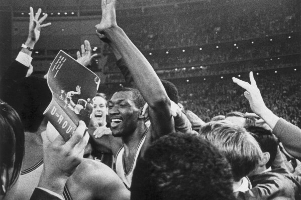 FILE - Houston's Elvin Hayes celebrates after defeating UCLA 71-69 in an NCAA college basketball game at the Astrodome in Houston, Jan. 20, 1968. (Sam Pierson Jr./Houston Chronicle via AP, File)/Houston Chronicle via AP)