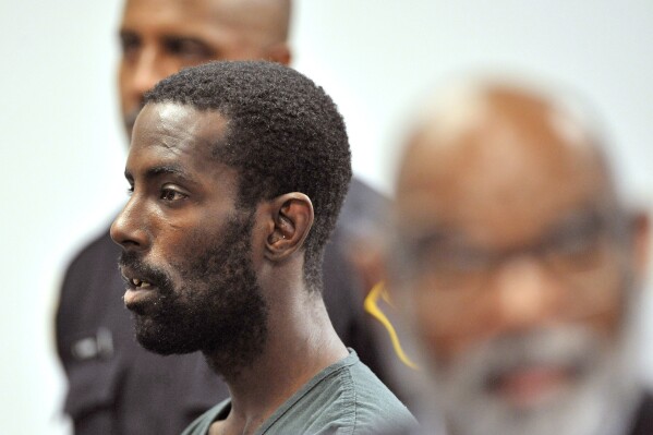 FILE - DeAngelo Martin stands for a probable cause hearing, in Detroit on June 20, 2019. DeAngelo Martin killed four women and raped two others before being captured in 2019. Repeatedly over the previous 15 years Detroit police failed to follow up on leads or take investigative steps that may have averted the killing spree, an Associated Press investigation has found. (Todd McInturf/Detroit News via AP, File)