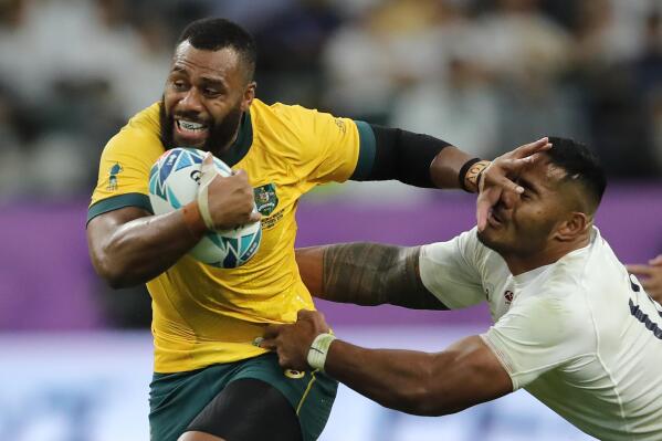 FILE - In this Oct. 19, 2019 file photo, Australia's Samu Kerevi fends off an England's Manu Tuilagi during the Rugby World Cup quarterfinal match at Oita Stadium in Oita, Japan. Kerevi has been named in the Australian 7's squad for the Tokyo Olympics. (AP Photo/Christophe Ena,File)