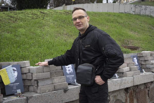 Dmytro Riznychenko, who took part in the uprising that eventually ousted Ukraine’s Moscow-friendly president, visits a memorial to the victims in Kyiv, Ukraine, on Thursday, Nov. 16, 2023. On Nov. 21, Ukraine marks the 10th anniversary of the protests, which lasted for months and led to the deaths of over 100 people. (AP Photo/Efrem Lukatsky)