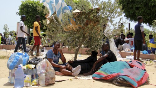 Migrants rest during a gathering in Sfax, Tunisia's eastern coast, Friday, July 7, 2023. Tensions spiked dangerously in a Tunisian port city this week after three migrants were detained in the death of a local man, and there were reports of retaliation against Black foreigners and accounts of mass expulsions and alleged assaults by security forces. (AP Photo)