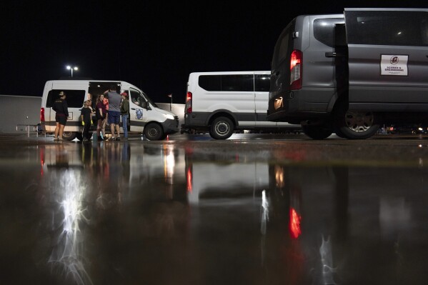 Members of Project ICECHIP gather in the Walmart parking lot to measure, weigh and crush hail during an operation late Friday, June 6, 2025, in Levelland, Texas. (AP Photo/Carolyn Kaster)