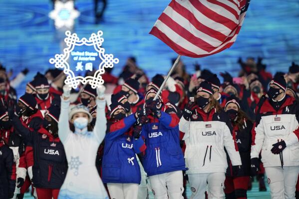 Brittany Bowe and John Shuster, of the United States, leads their team in during the opening ceremony of the 2022 Winter Olympics, Friday, Feb. 4, 2022, in Beijing. (AP Photo/David J. Phillip)