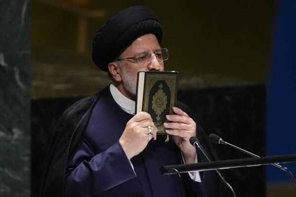 Iran’s President Ebrahim Raisi kisses a Quran as he addresses the 78th session of the United Nations General Assembly at United Nations headquarters, Tuesday, Sept. 19, 2023. (AP Photo/Seth Wenig)