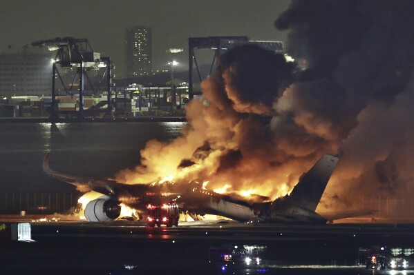 Um avião da Japan Airlines pega fogo na pista do aeroporto de Haneda na terça-feira, 2 de janeiro de 2024, em Tóquio, Japão.  Um avião de passageiros colidiu com um avião da Guarda Costeira japonesa e pegou fogo na pista do aeroporto de Haneda, em Tóquio, na terça-feira, disseram autoridades.  (Notícias Kyodo via Associated Press)