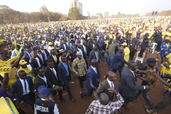 Zimbabwe's main opposition leader Nelson Chamisa is surrounded by security as he leaves his last campaign rally in Harare, Monday, Aug 21, 2023. The upcoming general election in Zimbabwe is crucial to determining the future of a southern African nation endowed with vast mineral resources and rich agricultural land. But for many in the educated but underemployed population, the daily grind to put food on the table inhibits interest in politics. (AP Photo/Tsvangirayi Mukwazhi)