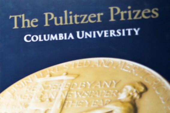 FILE - Signage for The Pulitzer Prizes appear at Columbia University on May 28, 2019, in New York. The Pulitzer Prize Board has revised its longtime rules on eligibility for many of its arts awards, and will now allow those not born in the U.S. and other non-citizens to compete. (AP Photo/Bebeto Matthews, File)
