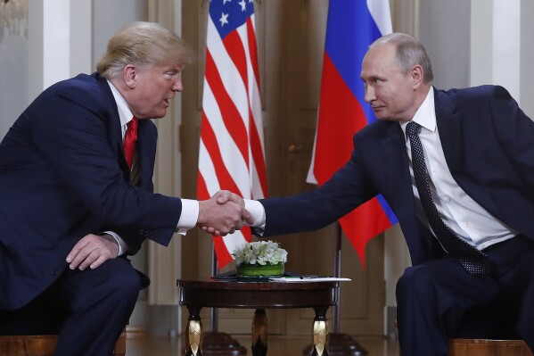 FILE - U.S. President Donald Trump, left, and Russian President Vladimir Putin, right, shake hands at the beginning of a meeting at the Presidential Palace in Helsinki, Finland, July 16, 2018. (AP Photo/Pablo Martinez Monsivais, File)