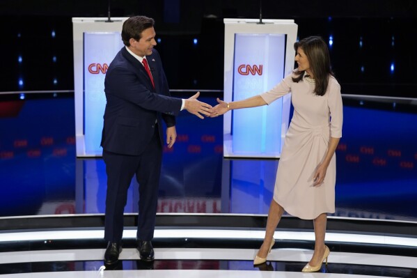 Aged UN Ambassador Nikki Haley, appropriate, and Florida Gov. Ron DeSantis, left, shaking fingers at the open up of the CNN Republican presidential debate at Drake University in Des Moines, Iowa, Wednesday, Jan. 10, 2024. (AP Describe/Andrew Harnik)