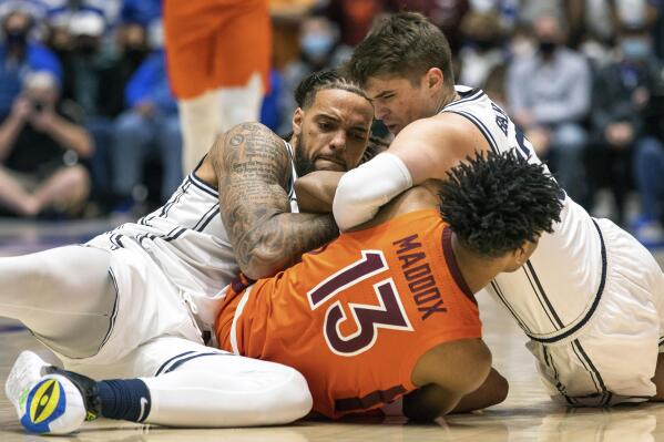 Virginia Tech's Darius Maddox (13) battles Duke's Theo John, left, and Duke's Joey Baker, right, for a loose ball during the first half of an NCAA college basketball game in Durham, N.C., Wednesday, Dec. 22, 2021. (AP Photo/Ben McKeown)