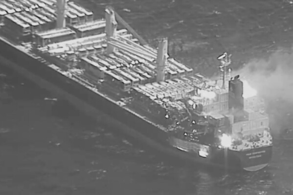 This black-and-white image released by the U.S. military's Central Command shows the fire aboard the bulk carrier True Confidence after a missile attack by Yemen's Houthi rebels in the Gulf of Aden on Wednesday, March 6, 2024. A missile attack by Yemen's Houthi rebels on a commercial ship in the Gulf of Aden on Wednesday killed three of its crew members and forced survivors to abandon the vessel, the U.S. military said. It was the first fatal strike in a campaign of assaults by the Iranian-backed group over Israel's war on Hamas in the Gaza Strip. (U.S. Central Command via AP)