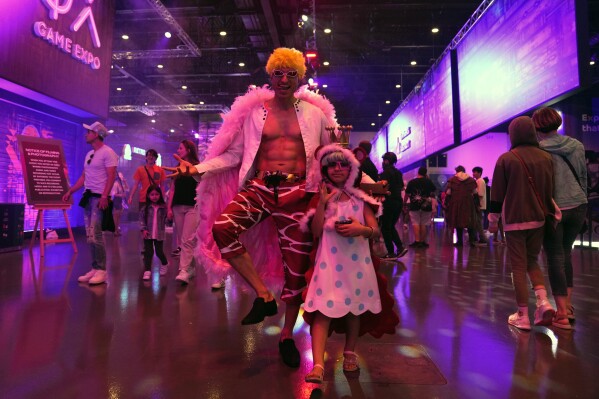 Gaming fans dressed in cosplay outfits attend the Dubai Esports and Games Festival in Dubai, United Arab Emirates, Saturday, June 24, 2023. Saudi Arabia, the new home of some of soccer’s biggest stars and a co-owner of professional golf, is proving to be no less ambitious when it comes to another global pastime, the $180 billion-a-year video game industry. (AP Photo/Kamran Jebreili)