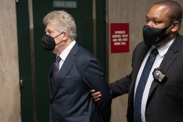 FILE - Glenn Horowitz, left, arrives to criminal court after being indicted for conspiracy involving handwritten notes for the Eagles album "Hotel California," July 12, 2022, in New York. On Wednesday, Feb. 21, 2024, an unusual criminal trial is set to open over the handwritten lyrics. (AP Photo/John Minchillo, File)