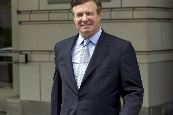 FILE - In this May 23, 2018, file photo, Paul Manafort, President Donald Trump's former campaign chairman, leaves the Federal District Court after a hearing in Washington. New York prosecutors have asked federal prison officials to transfer Manafort to New York City so he can be arraigned on state fraud charges. He is currently serving a 7 1/2-year sentence for bank fraud and other offenses at a prison in Pennsylvania. But he is also under indictment on similar state charges in New York. Two people familiar with the matter confirmed the transfer request Tuesday, June 4, 2019.  (AP Photo/Jose Luis Magana, File)