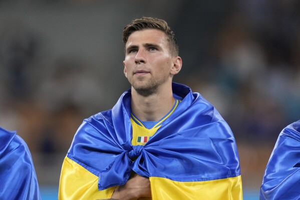 FILE - Ukraine's Illia Zabarnyi stands prior to the start of the Euro 2024 group C qualifying soccer match between Italy and Ukraine at the San Siro stadium, in Milan, Italy, Tuesday, Sept. 12, 2023. Age is a big factor in Group E at the European Championship as Belgium grapples with how to move on from its “Golden Generation” and Ukraine looks to its young players for inspiration during wartime. (AP Photo/Antonio Calanni, File)