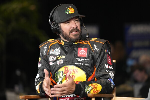 Martin Truex Jr. answers questions during an interview at the NASCAR Daytona 500 auto racing media day at Daytona International Speedway, Wednesday, Feb. 14, 2024, in Daytona Beach, Fla. (AP Photo/John Raoux)