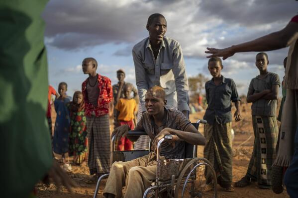 FILE - Displaced people who have arrived at a camp wait for plot allocation on the outskirts of Dollow, Somalia, on Sept. 19, 2022. Somalia is in the midst of the worst drought anyone there can remember. The head of the Nobel Peace Prize-winning World Food Program, on Tuesday, Jan. 17, 2023, says support from donors like the United States and Germany have allowed it to postpone — though not entirely avert — famine in Somalia(AP Photo/Jerome Delay, File)