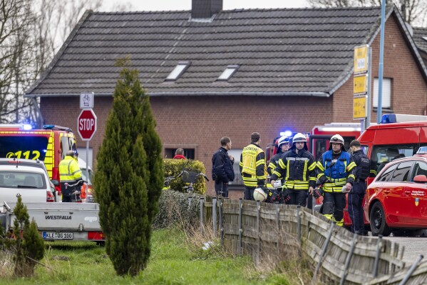 Police and fire department personnel stand by a retirement home after a fire broke out during the night, in Bedburg-Hau in the western German state of North Rhine-Westphalia, Monday, March 4, 2024. According to reports, few people died and at least 21 were injured. The cause of the fire is being investigated. (Christoph Reichwein/dpa via AP)