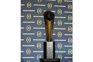 FILE - The national championship trophy is seen before a new conference for the NCAA college football playoff championship game between Clemson and Alabama, Sunday, Jan. 10, 2016, in Glendale, Ariz. The College Football Playoff announced Thursday, Dec. 1, 2022, it will expand to a 12-team event, starting in 2024, finally completing an 18-month process that was fraught with delays and disagreements.The announcement comes a day after the Rose Bowl agreed to amend its contract for the 2024 and '25 seasons, the last hurdle CFP officials needed cleared to triple the size of what is now a four-team format.(AP Photo/David J. Phillip, File)