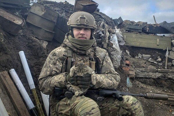 In this undated photo taken on the front-line, provided by Viktor Biliak, a Ukrainian infantryman with the 110th brigade, poses for a photo, in Avdiivka, Donetsk region, Ukraine. The loss of the city of Avdiivka in February 2024 marked the end of a long, exhausting defense for the Ukrainian military. One brigade had defended the same block of buildings for months without a break. Another unit had been in the city for nearly two years. (Viktor Biliak via AP)