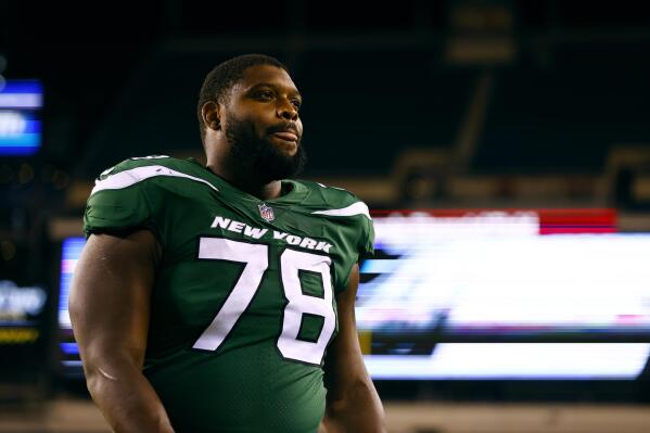 FILE - New York Jets offensive lineman Laken Tomlinson (78) walks off the field after an NFL preseason game against the Philadelphia Eagles, Friday, Aug. 12, 2022, in Philadelphia. Tomlinson cries before every game thinking about the daughter his family lost three years ago. The memory of Claire Abigail's death just 18 days after she was born still motivates him. He tells The Associated Press he's not sure where he'd be right now if not for the support of family and close friends. (AP Photo/Rich Schultz, File)
