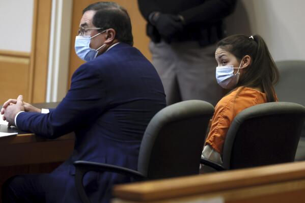 Kayla Montgomery, right, stepmother of missing girl Harmony Montgomery, sits beside her attorney Paul Garrity, left, in Hillsborough County Superior Court North, in Manchester, N.H., Monday, Jan. 24, 2022, where she pleaded not guilty to charges accusing her of lying last year that Harmony was in her household to claim food stamp benefits. (Jessica Rinaldi/The Boston Globe via AP, Pool)