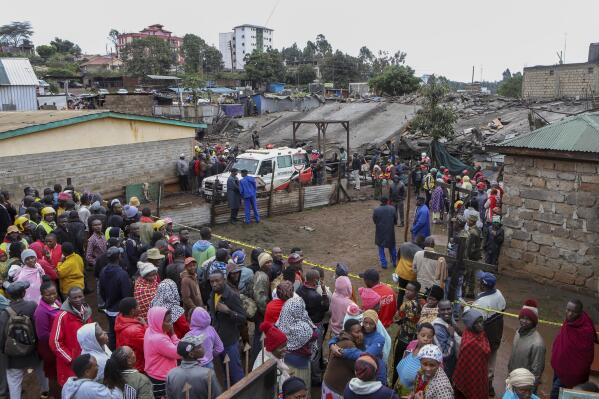 Onlookers gather at the scene of a building collapse in Ruaka, on the outskirts of the capital Nairobi, Kenya Thursday, Nov. 17, 2022. The collapse of the building under construction is the second such collapse in a matter of days in Nairobi, where housing is in high demand and unscrupulous developers often bypass regulations. (AP Photo)