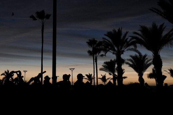 People watch a total solar eclipse as the sky goes dark in Mazatlan, Mexico, Monday, April 8, 2024. (AP Photo/Fernando Llano)