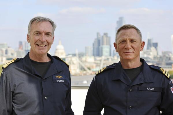 Daniel Craig, right, receives the honorary Royal Navy rank of Commander from the Head of the Royal Navy, First Sea Lord Admiral Sir Tony Radakin KCB ADC, left, in London, Wednesday Sept. 22, 2021. (LPhot Lee Blease/Ministry of Defence via AP)