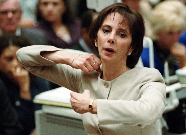 FILE - FILE - In this Sept. 26, 1995, file photo, prosecutor Marcia Clark demonstrates to the jury how the murders of Nicole Brown Simpson and Ron Goldman were committed during her closing arguments in O.J. Simpson's double-murder trial in Los Angeles. Simpson, the decorated football superstar and Hollywood actor who was acquitted of charges he killed his former wife and her friend but later found liable in a separate civil trial, has died. He was 76. (Myung J. Chun/Los Angeles Daily News via AP, Pool, File)