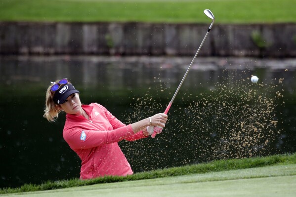 FILE - Paula Creamer hits out of a bunker during the first round at the Women's PGA Championship golf tournament at Sahalee Country Club on June 9, 2016, in Sammamish, Wash. The Seattle area will get a taste of major golf this week when the KPMG Women’s PGA Championship is played at Sahalee for the second time. The course hosted the tournament in 2016 and served as the conclusion to a run of big golf events that visited the Puget Sound region during a six-year window that began in 2010. (AP Photo/Elaine Thompson, File)