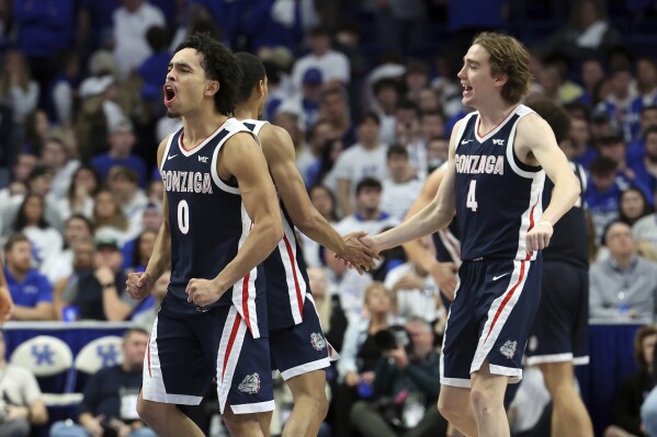 Gonzaga's Ryan Nembhard (0) and Dusty Stromer (4) celebrate the team's win over Kentucky in an NCAA college basketball game Saturday, Feb. 10, 2024, in Lexington, Ky. (AP Photo/James Crisp)