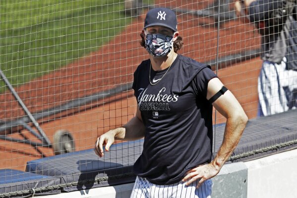 New York Yankees starting pitcher Gerrit Cole looks into the stands, empty except for a handful of media, during a baseball summer training camp workout Sunday, July 5, 2020, at Yankee Stadium in New York. (AP Photo/Kathy Willens)