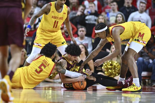 Maryland guard Eric Ayala (5) and Minnesota guard E.J. Stephens compete for possession of the ball during the second half of an NCAA college basketball game Wednesday, March 2, 2022, in College Park, Md. (AP Photo/Terrance Williams)