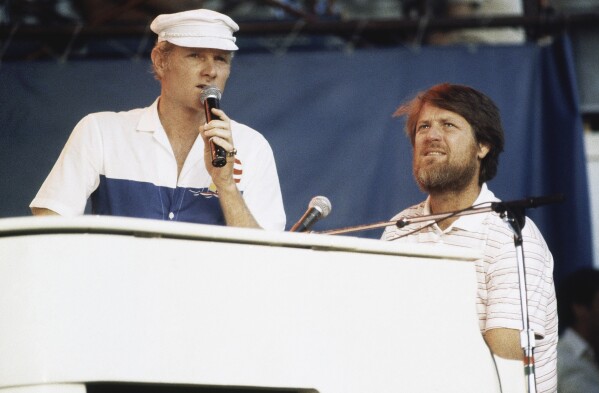 Mike Love, left, and Brian Wilson of The Beach Boys, perform at the Miller Time concert on Pier 84 on July 8, 1983 in New York. (AP Photo/ David Handschuh, File)