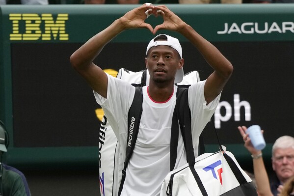 Christopher Eubanks of the US gestures to the crowd after losing to Russia's Daniil Medvedev in their men's singles match on day ten of the Wimbledon tennis championships in London, Wednesday, July 12, 2023. (AP Photo/Alastair Grant)