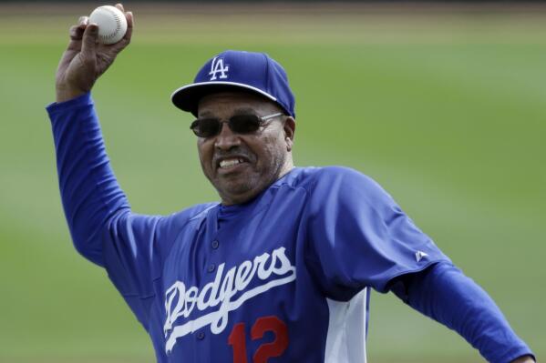 FILE - Former Los Angeles Dodgers great Tommy Davis throws out a ceremonial pitch before an exhibition spring training baseball game against the Seattle Mariners, Saturday, March 9, 2013, in Glendale, Ariz. Davis, a two-time National League batting champion who won three World Series titles with the Los Angeles Dodgers, died Sunday night, April 3, 2022, in Phoenix, the Dodgers announced Monday. He was 83. (AP Photo/Mark Duncan, File)