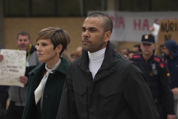 Brazilian soccer star Dani Alves, right, leaves Brians 2 penitentiary center in Sant Esteve Sesrovires, near Barcelona, northeast, Spain, Monday, March 25, 2024. (AP Photo/Emilio Morenatti, file)