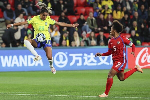 Brazil's Gabi Nunes, left, is airborne as she attempts to control the ball as Panama's Yomira Pinzon watches during the Women's World Cup Group F soccer match between Brazil and Panama in Adelaide, Australia, Monday, July 24, 2023. (AP Photo/James Elsby)