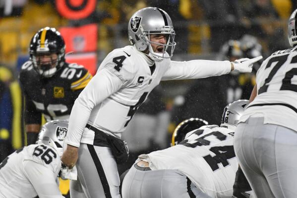 Las Vegas Raiders quarterback Derek Carr (4) calls signals during the first half of an NFL football game against the Pittsburgh Steelers in Pittsburgh, Saturday, Dec. 24, 2022. (AP Photo/Don Wright)